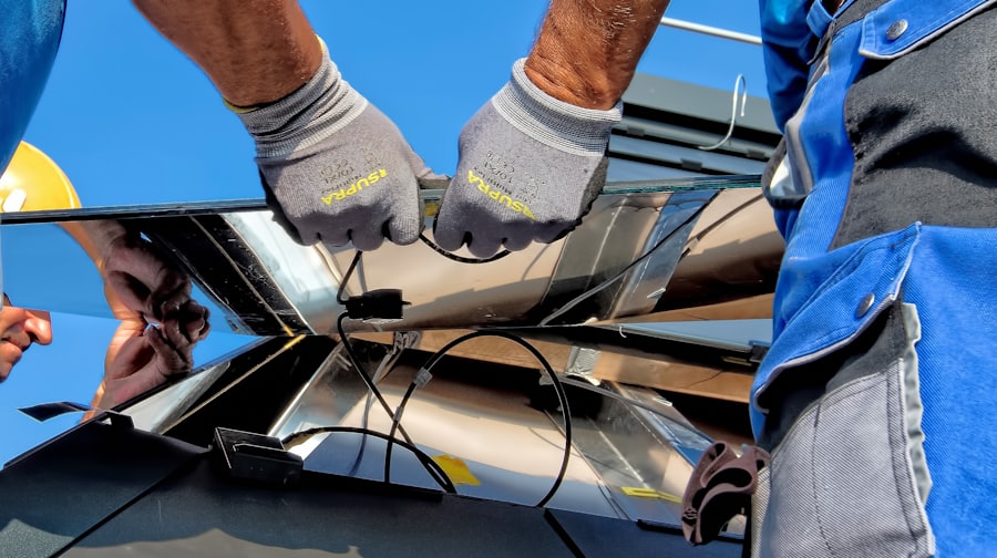 Technician cleaning and maintaining solar panels